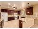 Large kitchen with ample cabinetry, granite counters, and breakfast bar at 12677 N 140Th Dr, Surprise, AZ 85379