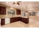 Kitchen features granite countertops, dark wood cabinets, and island at 12677 N 140Th Dr, Surprise, AZ 85379