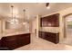 Spacious kitchen with granite countertops and dark wood cabinets at 12677 N 140Th Dr, Surprise, AZ 85379