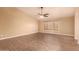 Bright living room with wood-look flooring and ceiling fan at 12677 N 140Th Dr, Surprise, AZ 85379