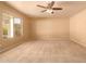 Living room featuring neutral walls, carpet, and large window at 12677 N 140Th Dr, Surprise, AZ 85379