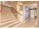 Elegant staircase with wooden handrail leading to the second floor at 12677 N 140Th Dr, Surprise, AZ 85379