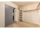 Large walk-in closet with shelving and mirrored sliding doors at 12677 N 140Th Dr, Surprise, AZ 85379