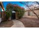 Landscaped backyard with gated entry and stone pathway at 14033 W Two Guns Trl, Surprise, AZ 85374