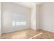 Well-lit bedroom featuring tile flooring and window blinds at 14033 W Two Guns Trl, Surprise, AZ 85374