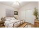 Cozy bedroom with a metal bed frame, decorative accents, and a wardrobe at 14033 W Two Guns Trl, Surprise, AZ 85374