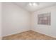 Simple bedroom with large window and ceiling fan at 14033 W Two Guns Trl, Surprise, AZ 85374