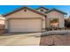 Tan house with a two-car garage and small front yard at 14033 W Two Guns Trl, Surprise, AZ 85374