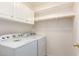 Laundry room with washer, dryer, and cabinets at 14033 W Two Guns Trl, Surprise, AZ 85374