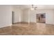 Spacious living room with tile flooring and a ceiling fan at 14033 W Two Guns Trl, Surprise, AZ 85374