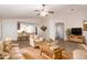 Inviting living room featuring neutral tones, tile floors, ceiling fan, and seamlessly flowing into the adjacent kitchen at 14033 W Two Guns Trl, Surprise, AZ 85374