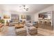 Spacious living room features two sofas, a rustic coffee table, and a ceiling fan, ideal for relaxing and entertaining at 14033 W Two Guns Trl, Surprise, AZ 85374