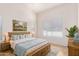 Serene main bedroom with a wooden bed frame, neutral linens, and ample natural light at 14033 W Two Guns Trl, Surprise, AZ 85374