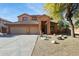 Two-story house with a three-car garage and nicely landscaped front yard at 1440 S Central Dr, Chandler, AZ 85286