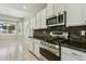 Modern kitchen features gas range, stone backsplash, and white cabinets at 1440 S Central Dr, Chandler, AZ 85286