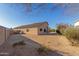 Sandy backyard with desert landscaping and a view of the house at 14529 N 87Th Dr, Peoria, AZ 85381