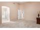 Bedroom with carpet, door to bathroom and large window at 14529 N 87Th Dr, Peoria, AZ 85381