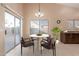 Bright dining area with table and chairs, view to backyard at 14529 N 87Th Dr, Peoria, AZ 85381