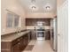 Kitchen with stainless steel appliances and dark wood cabinets at 14529 N 87Th Dr, Peoria, AZ 85381