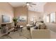 Living room with vaulted ceiling, sectional sofa, and large TV at 14529 N 87Th Dr, Peoria, AZ 85381