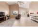 Living room with tiled floor, ceiling fan, and recliner at 14529 N 87Th Dr, Peoria, AZ 85381