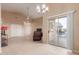 Living room with tiled floors, ceiling fan, and access to patio at 14529 N 87Th Dr, Peoria, AZ 85381