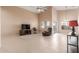 Living room with tiled floor, ceiling fan, and recliner at 14529 N 87Th Dr, Peoria, AZ 85381