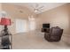 Living room with tiled floors, ceiling fan, and access to patio at 14529 N 87Th Dr, Peoria, AZ 85381