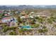 Aerial view of house, pool, and pickleball courts, with mountain backdrop at 15225 N Bluejay Pl, Fountain Hills, AZ 85268