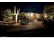 Stunning curb appeal at night, with a large house and mature landscaping at 15225 N Bluejay Pl, Fountain Hills, AZ 85268