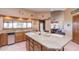 Kitchen island with seating and granite countertop at 15225 N Bluejay Pl, Fountain Hills, AZ 85268