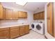 Laundry room with washer, dryer, and wood cabinets at 15225 N Bluejay Pl, Fountain Hills, AZ 85268