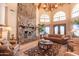 Living room with a large stone fireplace and high ceilings at 15225 N Bluejay Pl, Fountain Hills, AZ 85268