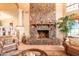 Elegant living room featuring a large stone fireplace and comfortable seating at 15225 N Bluejay Pl, Fountain Hills, AZ 85268