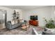 Living room featuring a gray sofa, coffee table, and built-in shelving at 1531 W Colter St # 10, Phoenix, AZ 85015