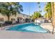 Community pool with surrounding patio and palm trees at 1531 W Colter St # 10, Phoenix, AZ 85015