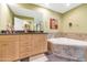 Elegant bathroom with double vanity and a corner bathtub at 16 W Encanto Blvd -- # 128, Phoenix, AZ 85003