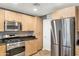 Well-equipped kitchen featuring wood cabinets and stainless steel appliances at 16 W Encanto Blvd -- # 128, Phoenix, AZ 85003