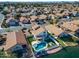 Aerial view showcasing a home with a pool, located by a lake in a residential area at 1610 W Maplewood St, Chandler, AZ 85286