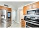 Stainless steel appliances and wood cabinets in this kitchen at 1610 W Maplewood St, Chandler, AZ 85286