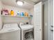 Laundry room with washer, dryer, and shelving at 1610 W Maplewood St, Chandler, AZ 85286