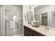 Bright bathroom with double sink vanity, tiled shower, white towels, and modern finishes at 1693 E Dogwood Ln, Gilbert, AZ 85295