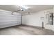 Spacious two car garage featuring white walls, concrete floors, and ample room for vehicles at 1693 E Dogwood Ln, Gilbert, AZ 85295