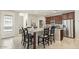 Open concept kitchen with a granite island, seating for six, stainless steel appliances, and dark wood cabinets at 1693 E Dogwood Ln, Gilbert, AZ 85295
