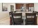 Close up of a kitchen island with granite countertops, seating for six and decorative place settings at 1693 E Dogwood Ln, Gilbert, AZ 85295