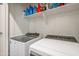 Laundry room with washer and dryer and overhead shelving at 1693 E Dogwood Ln, Gilbert, AZ 85295