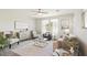 Bright living room with modern decor, neutral tones, ceiling fan, and plenty of natural light at 1693 E Dogwood Ln, Gilbert, AZ 85295