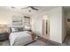 Main bedroom featuring neutral decor, large window, ceiling fan, and en suite access at 1693 E Dogwood Ln, Gilbert, AZ 85295