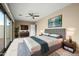 Main bedroom with access to balcony and ceiling fan at 17680 N 77Th Pl, Scottsdale, AZ 85255