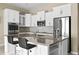 Modern kitchen with stainless steel appliances and breakfast bar at 17680 N 77Th Pl, Scottsdale, AZ 85255